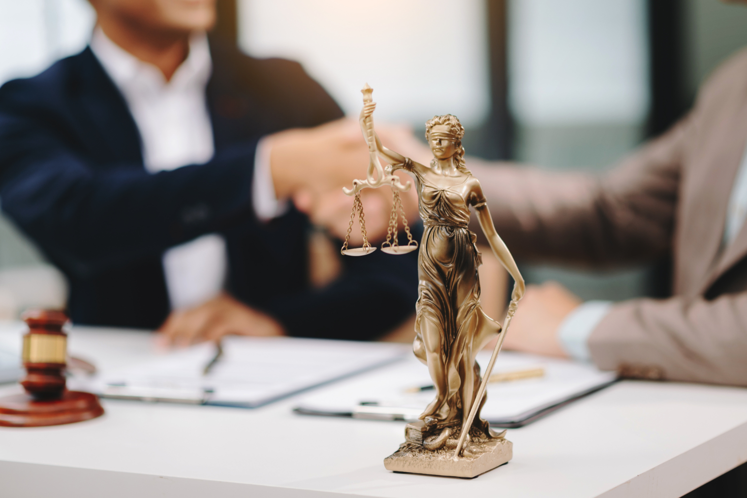 Male lawyer in the office with brass scale on wooden table.